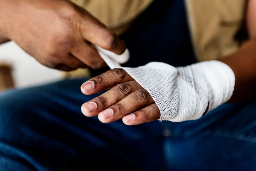 adult wraps injured hand with white gauze 2026 09 25 08 00 28 utc