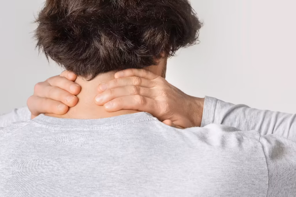 neck pain concept man rubs sore spot 2026 03 24 02 21 02 utc